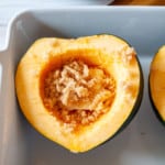 Squash filled with maple syrup, butter, and brown sugar, ready to bake.