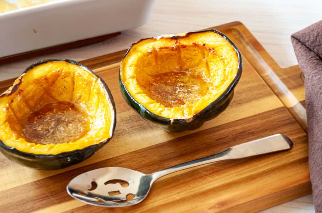 Ready to serve acorn squash roasted with butter, maple syrup, and brown sugar.