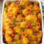 Tater tot breakfast casserole garnished with chopped bacons and scallions.