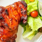 BBQ chicken made in the air fryer with a garden salad.
