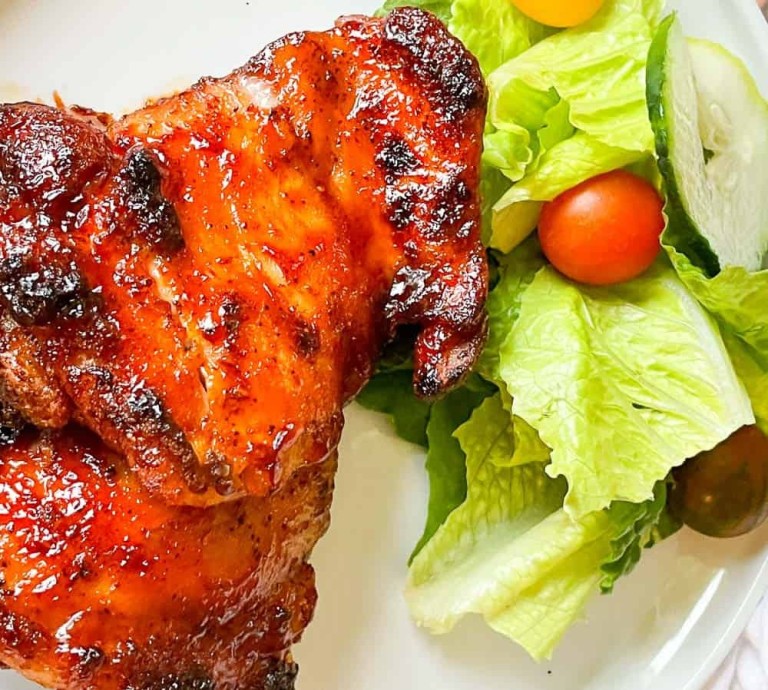 BBQ chicken made in the air fryer with a garden salad.