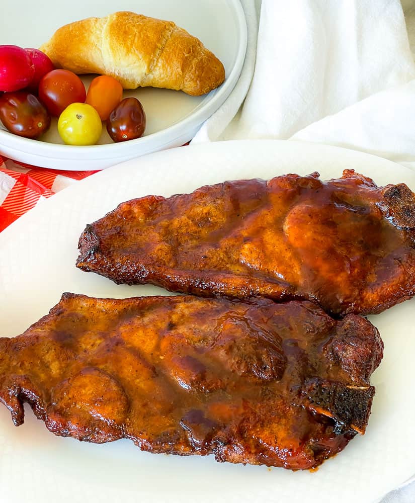 BBQ pork steak cooked in the air fryer on a plate.