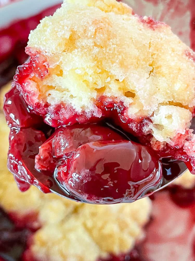 A scoop of cherry cobbler made with bing cherries.