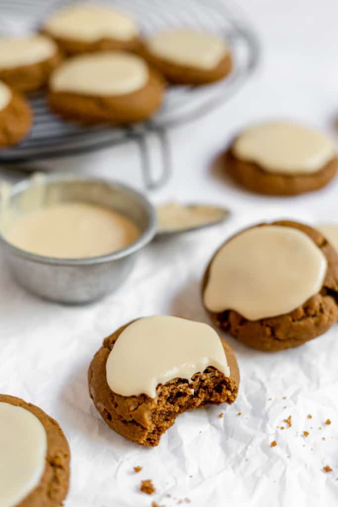 Iced cookies with icing and a cookie with a bite out of it. 