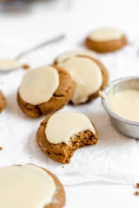 iced molasses cookies with a cup of icing too.