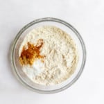 Dry ingredients for old-fashioned iced molasses cookies in a bowl.