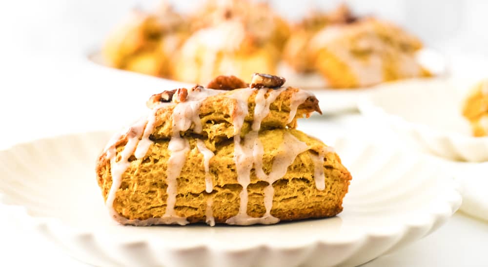 Cinnamon glazed pumpkin scone topped with candied pecans.