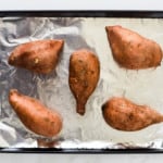 Sweet potatoes arranged in a baking pan before it goes into oven.