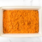 A large pan of mashed sweet potatoes.