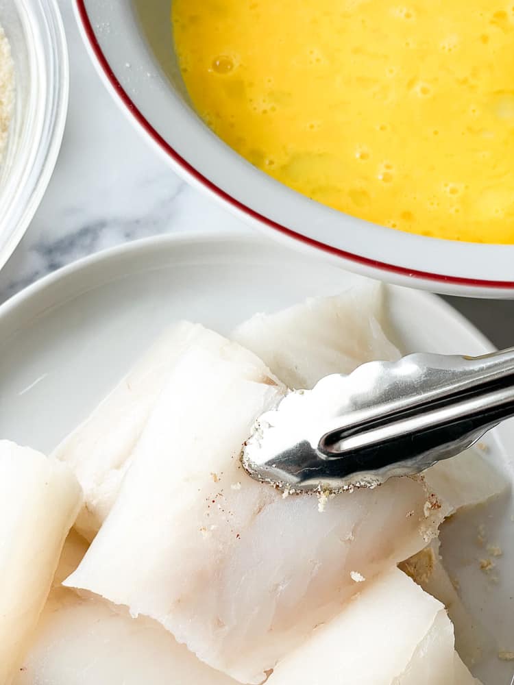 Dipping cod in eggs.