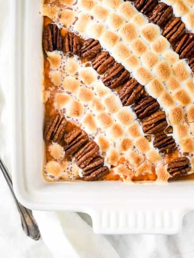 A casserole dish with s'mores and pecans.
