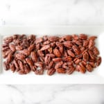 Sering candied pecans on a platter.