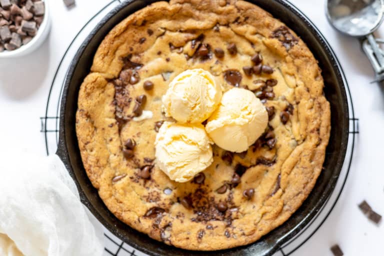 Giant chocolate chip cookie in a cast-iron skillet.