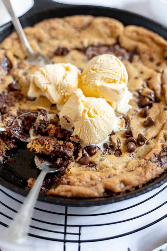 Pizookie with ice cream and spoons.