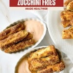 Two oval dishes filled with crispy Air Fryer Zucchini Fries sit next to a bowl of dipping sauce on a white table, with the recipe title displayed above.