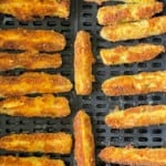 Fried zucchini in the air fryer basket.