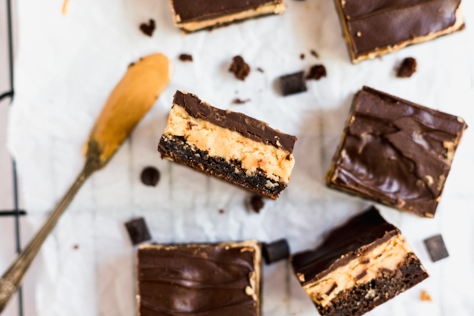 Layered Buckeye Brownies stacked up with more brownies around them.
