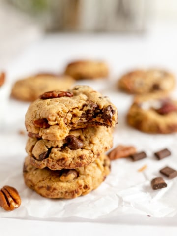 A stack of cookies with pecans and chocolate chips.