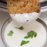 Dipping an Air Fryer Pickle in ranch dressing.