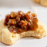 Pecan pie cookie with a bite taken out of it.