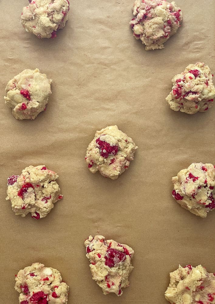 Raspberry cookies on a baking sheet.