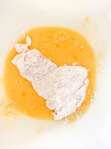 Floured chicken in egg.