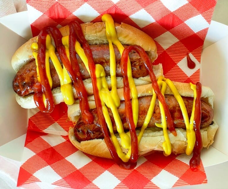 Aidells sausages in buns with ketchup and mustard.