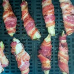 Finished bacon wrapped pickles in the air fryer basket.