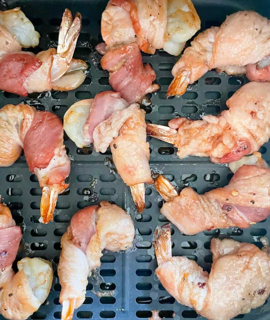Half cooked shrimp in the air fryer.