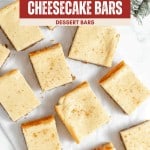 Top-down view of eggnog cheesecake squares arranged on parchment paper, with a festive red label reading "Easy Christmas Eggnog Cheesecake Bars" at the top.