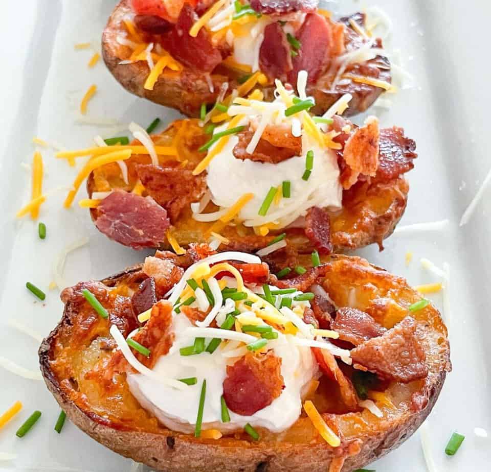 Crispy potato skins made in the air fryer on a platter.