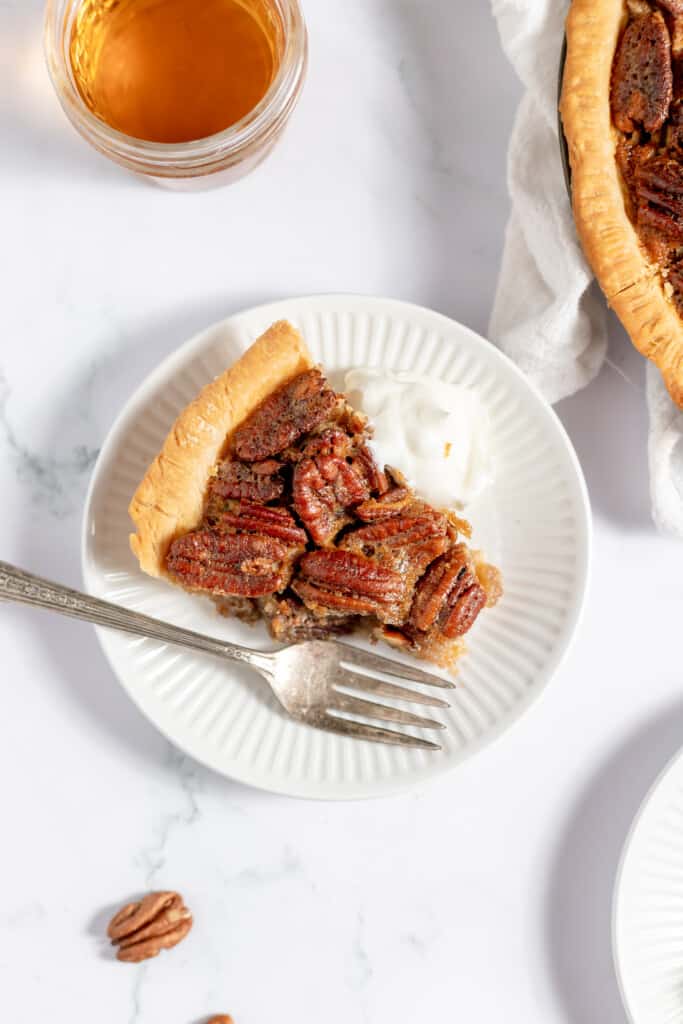 Bourbon Pecan Pie on a plate with a fork.