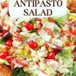 A close-up of an antipasto salad with lettuce, cherry tomatoes, olives, cheese, meats, and croutons. Text overlay reads "Italian Salad Ideas: Antipasto Salad" for delicious antipasto salad inspiration.