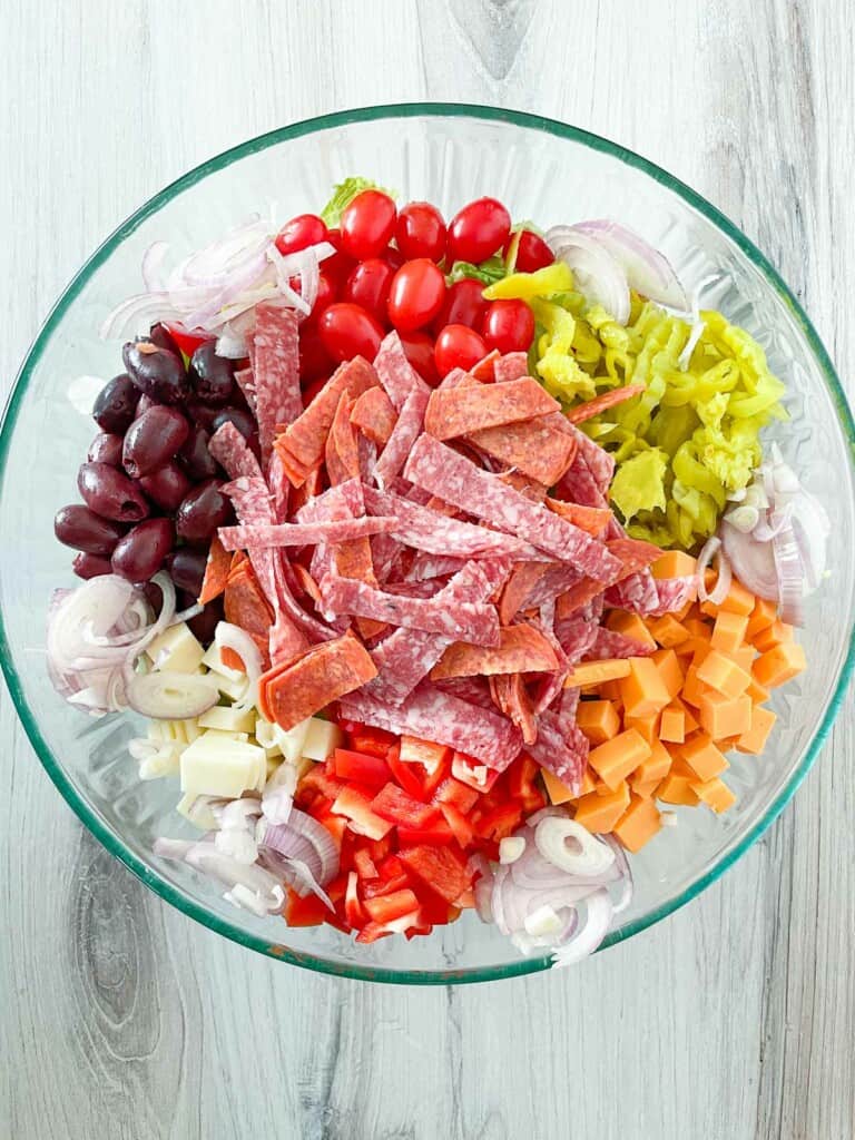 All the toppings on top of an antipasto salad.