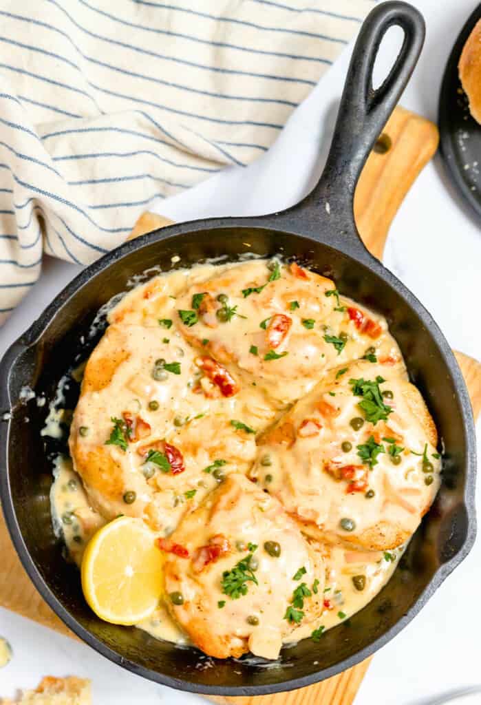 Lemony chicken piccata in a cast iron skillet.
