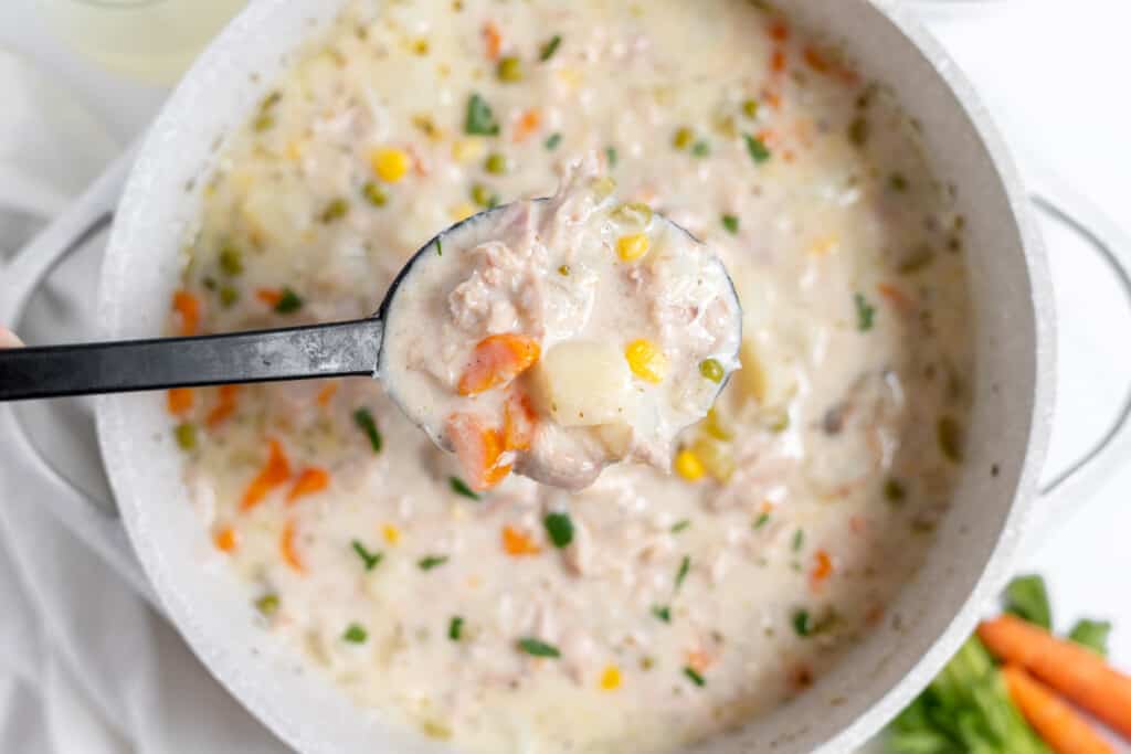 A spoonful of chicken pot pie soup.