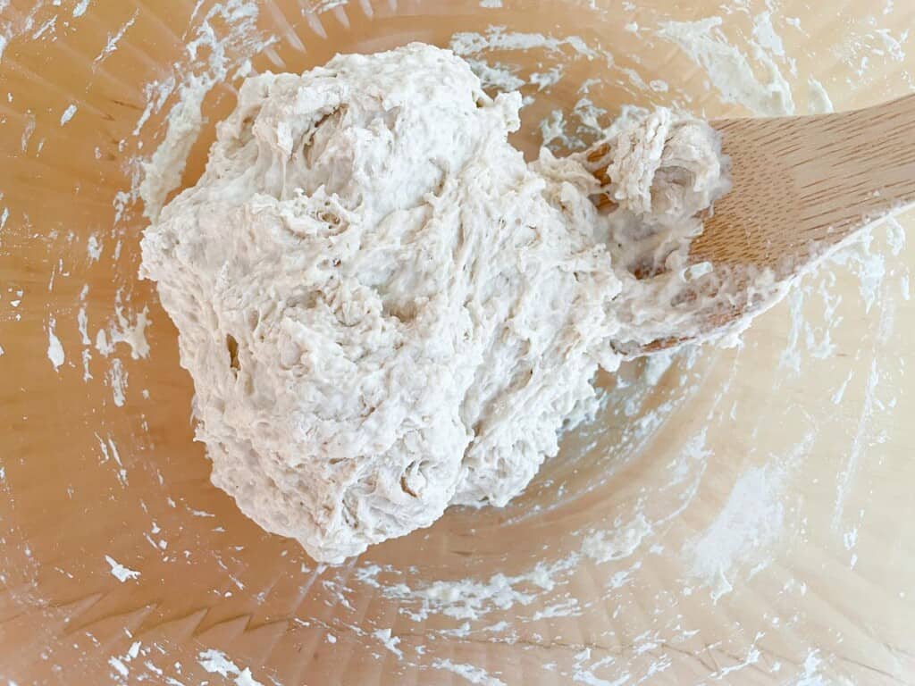 Sticky ball of bread dough ready to be kneaded.