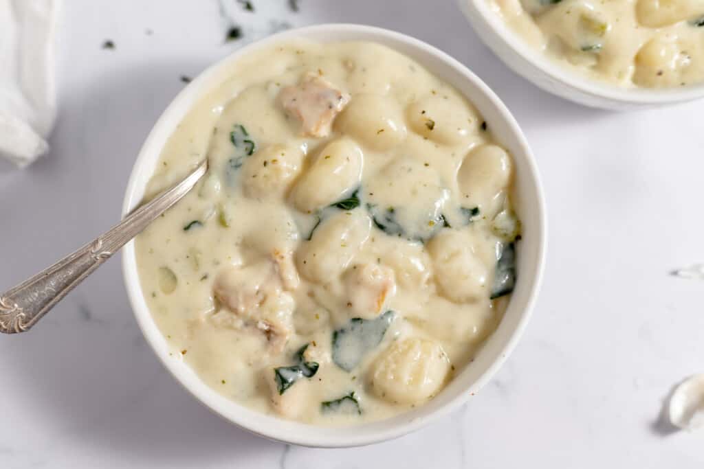 A bowl of chicken gnocchi soup.