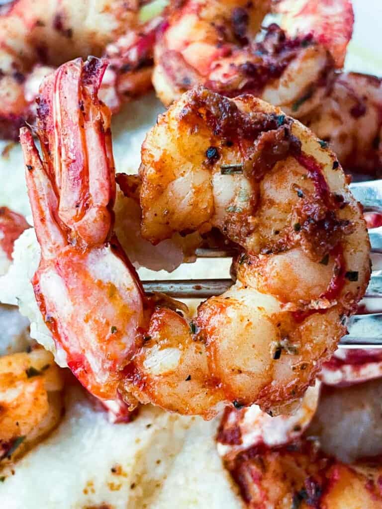An air-fried Cajun Shrimp on a fork.
