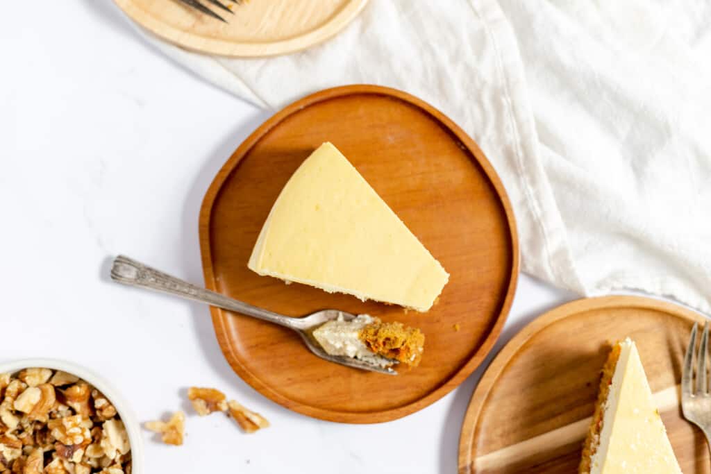 Top view carrot cake cheesecake slice with a bite taken out.