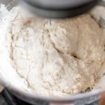 Flour mixing in the bowl of a stand mixer.