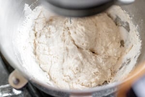 Flour mixing in the bowl of a stand mixer.