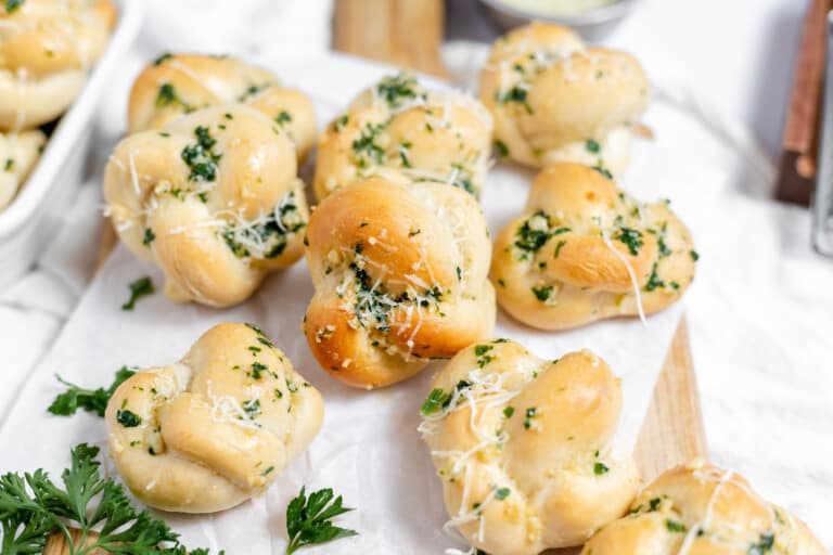 Delicious garlic knots on a wooden board.