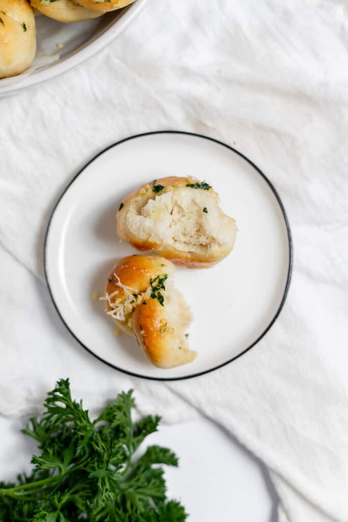 Inside of a fresh bread roll on a plate.