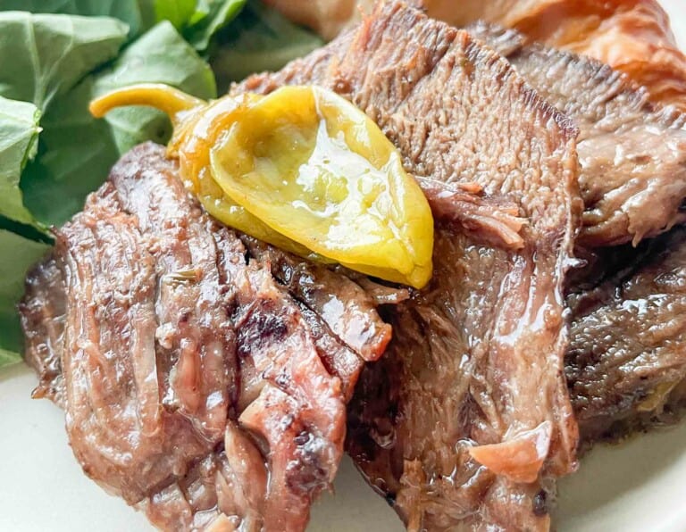Mississippi Pot Roast with a banana pepper and spinach on the side.