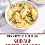 A bowl of Sausage Tortellini Soup with kale and a spoon sits beside another bowl and the partial view of a soup pot, showcasing this hearty, comforting dish.