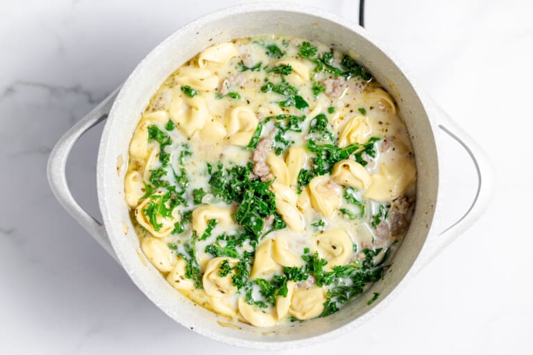 A pot full of creamy sausage tortellini soup.