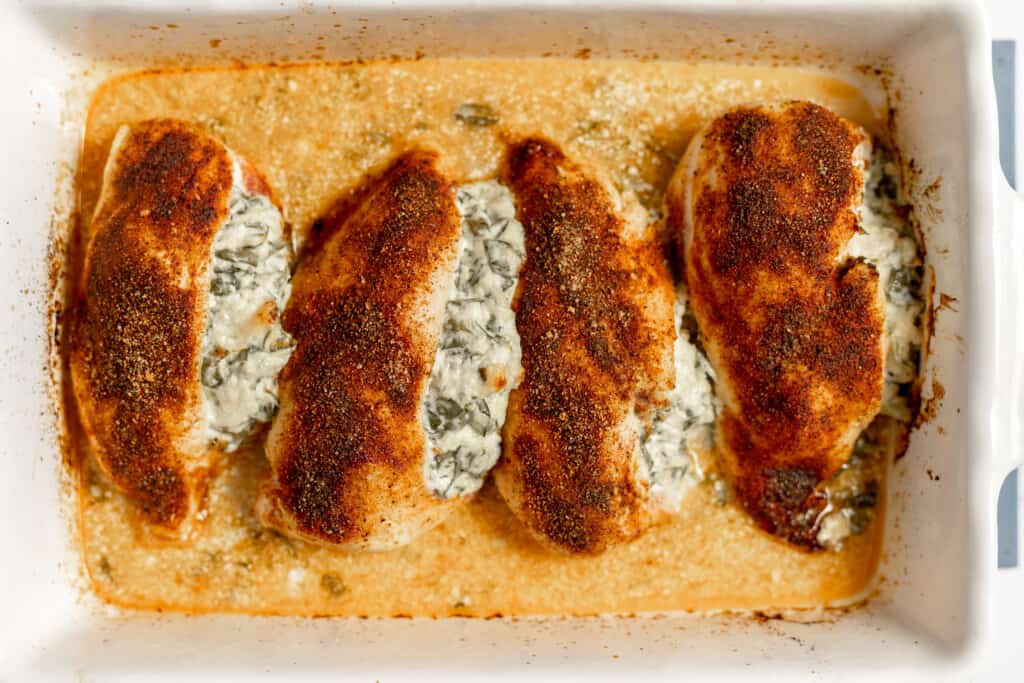 Finished stuffed chicken in a baking dish.