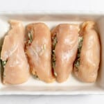 Chicken in the baking dish brushed with olive oil.