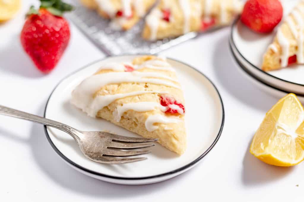 A plate with a scone and a fork on it.